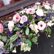 Pink and purple casket spray